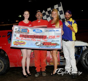 Ken Eckhoff with Miss Nebraska Cup Courtney Wulf and Miss Nebraska Cup finalist Jen Harter and flagman Billy Lloyd